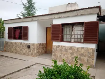 a house with two windows and a door at Buenas Vibras in Villa Carlos Paz