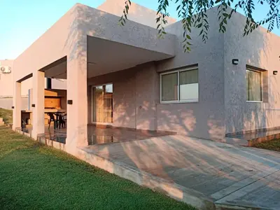 a house with a large patio in front of it at Bº CERRADO LOMAS DEL REY MAYU SUMAJ in San Antonio de Arredondo