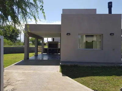 a house with a porch and a window on it at Bº CERRADO LOMAS DEL REY MAYU SUMAJ in San Antonio de Arredondo