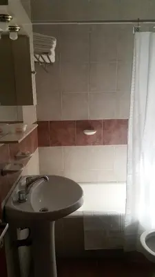 a bathroom with a sink and a shower curtain at Luminoso departamento en Cañada y a pasos de todo! in Cordoba