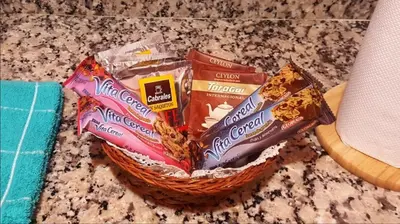 a basket filled with cookies and other snacks on a counter at Luminoso departamento en Cañada y a pasos de todo! in Cordoba