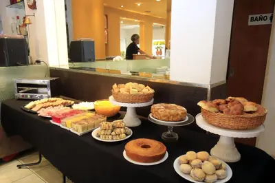 a table filled with different types of pastries and pies at Hotel Ananque in Villa Carlos Paz