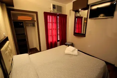 a bedroom with a bed with a towel on it at Hotel Ananque in Villa Carlos Paz