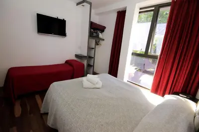 a hotel room with a bed and a window at Hotel Ananque in Villa Carlos Paz