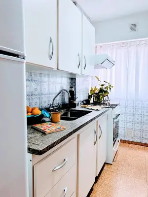 a kitchen with white cabinets and a counter top at El mejor Dpto en Nva Cordoba al alcance de todo!frente Sanatorio Allende in Cordoba