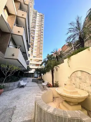 a building with a fountain in the middle of a courtyard at El mejor Dpto en Nva Cordoba al alcance de todo!frente Sanatorio Allende in Cordoba