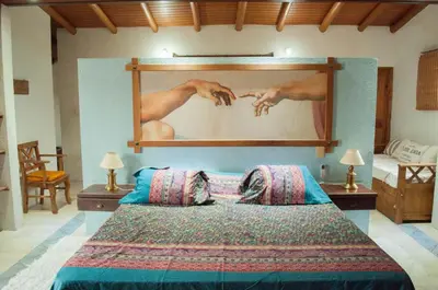 a bedroom with a large bed with a large painting on the wall at Casa Villa in Cordoba