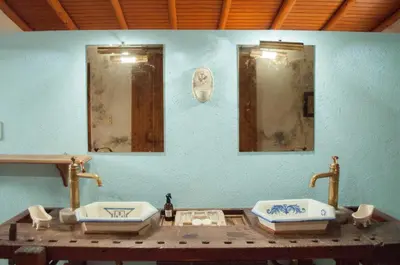 a bathroom with two sinks and two mirrors at Casa Villa in Cordoba