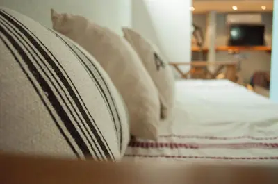 a close up of a bed with white sheets and pillows at Casa Villa in Cordoba