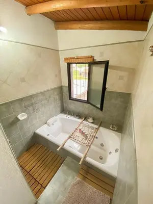 a large bathroom with a tub and a mirror at Casa Villa in Cordoba