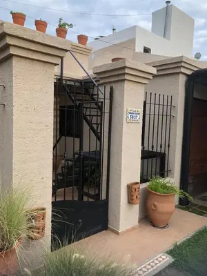 a house with a black gate and some plants at Casa Villa in Cordoba