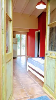 a bedroom with a bed and a red wall at apartamento VINTAGE IVA in Merlo