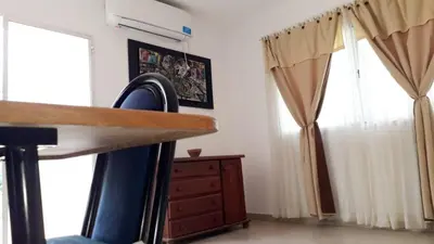 a kitchen with curtains and a dresser in a room at Casa con pileta privada in Tanti