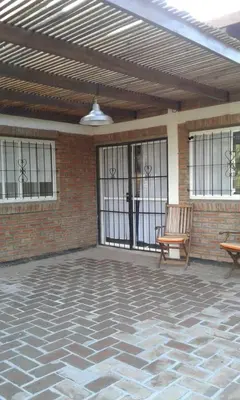 a patio with a bench and a brick wall at Cabañas de Montaña El Barranco in La Paz