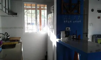 a kitchen with blue walls and a blue counter top at Cabañas de Montaña El Barranco in La Paz