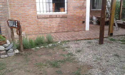 a brick house with a sign in front of it at Cabañas de Montaña El Barranco in La Paz
