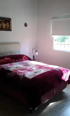 a bedroom with a large bed with a red blanket at Cabañas de Montaña El Barranco in La Paz