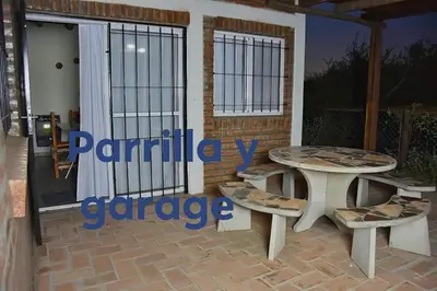 a patio with two picnic tables and a gate at Cabañas de Montaña El Barranco in La Paz