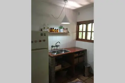 a kitchen with a sink and a refrigerator at Santa Rosa con parque y rio Ideal para familias in Santa Rosa de Calamuchita