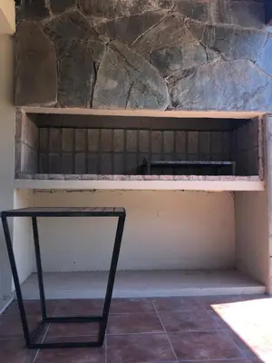 a bench with a table sitting on top of it at Complejo Verde Memoria in Merlo