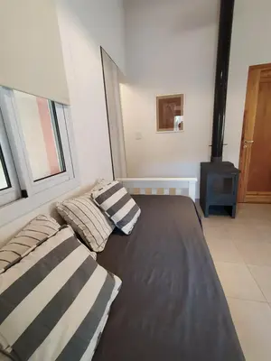 a bed with two pillows on it in a room at Complejo Verde Memoria in Merlo