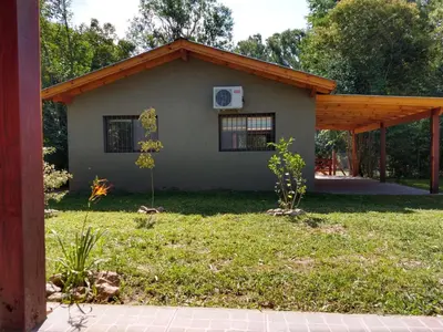 a house with a basketball hoop in the yard at Complejo El Bosque in Villa Ciudad Parque