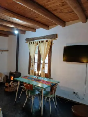 a dining room with a green table and chairs at Surya- en La Casa de Nanda in San Javier