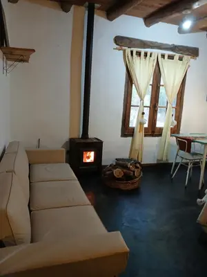 a living room with a couch and a wood stove at Surya- en La Casa de Nanda in San Javier