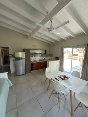 a kitchen and living room with a table and chairs at Departamentos la Piedad in Mina Clavero