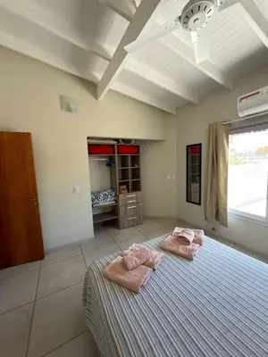 a bedroom with two pink towels on a bed at Departamentos la Piedad in Mina Clavero