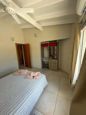 a bedroom with two pink towels on a bed at Departamentos la Piedad in Mina Clavero