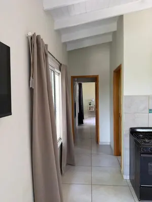 a hallway of a kitchen with curtains on a wall at Departamentos la Piedad in Mina Clavero