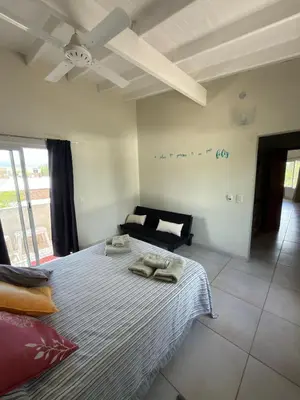a bedroom with a bed with two towels on it at Departamentos la Piedad in Mina Clavero