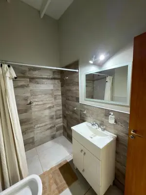 a bathroom with a sink and a mirror at Departamentos la Piedad in Mina Clavero
