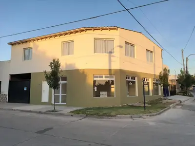 a yellow building on the corner of a street at Departamentos la Piedad in Mina Clavero