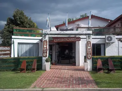a building with a brick walkway in front at Apart hotel Residencial El Puma in Mina Clavero
