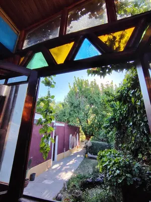 a view from a window of a yard at Andamundos Hostel in Mina Clavero