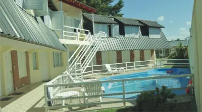 a balcony with a pool and a ladder next to a building at Duplex del Sol in Villa Carlos Paz