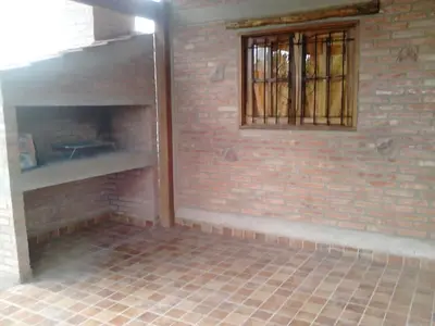 an empty room with a brick wall and a window at Cálidas Cabañas Las Piedras 2 , Villa Cura Brochero con wi fi in Villa Cura Brochero