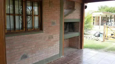 a brick building with a window and a brick wall at Cálidas Cabañas Las Piedras 2 , Villa Cura Brochero con wi fi in Villa Cura Brochero