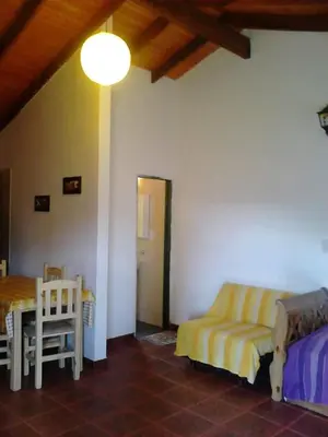 a living room with a couch and a table at Cálidas Cabañas Las Piedras 2 , Villa Cura Brochero con wi fi in Villa Cura Brochero