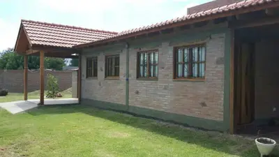 a brick house with a gazebo in a yard at Cálidas Cabañas Las Piedras 2 , Villa Cura Brochero con wi fi in Villa Cura Brochero