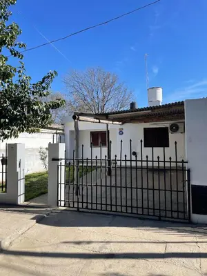 a white house with a gate in front of it at La Elvira in Alta Gracia