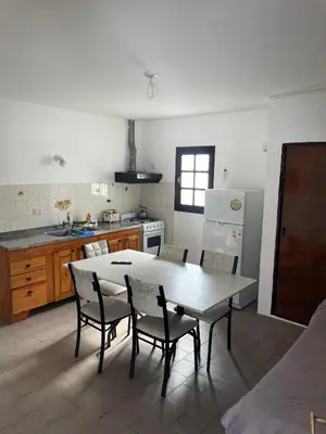 a kitchen with a table and chairs in it at La Elvira in Alta Gracia