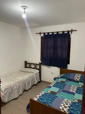a bedroom with two beds and a window at La Elvira in Alta Gracia