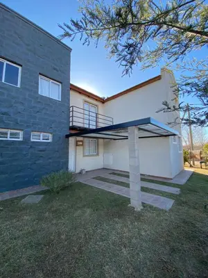a house with a blue and white building at Campos de Dios in Potrero de Garay