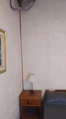 a bedroom with a bed and a lamp on a table at Campos de Dios in Potrero de Garay
