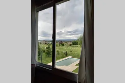 a window with a view of a swimming pool at Campos de Dios in Potrero de Garay
