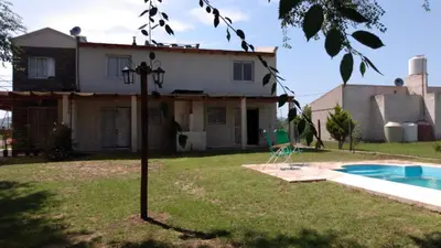 a house with a swimming pool in the yard at Campos de Dios in Potrero de Garay