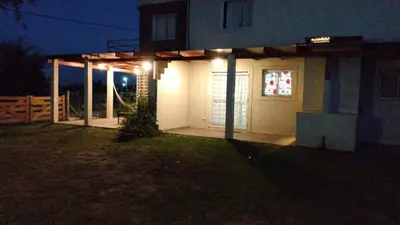 a house with a lit up garage at night at Campos de Dios in Potrero de Garay